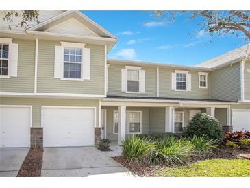 Charming townhome featuring a one car garage and well maintained landscaping at 2911 Bear Oak Dr, Valrico, FL 33594