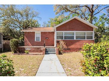 Charming brick home with a well-manicured front yard and walkway leading to the entrance at 2011 10Th S St, St Petersburg, FL 33705
