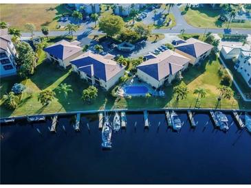 Stunning aerial view of waterfront condos, boat docks and a community pool at 3221 White Ibis Ct # B1, Punta Gorda, FL 33950