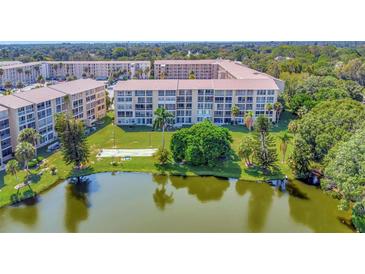 Beautiful lakefront condo complex with lush landscaping and serene water views at 3672 Lake Bayshore Dr # K327, Bradenton, FL 34205