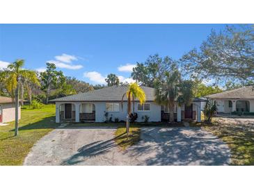 Charming single-story duplex featuring a well-manicured lawn and a convenient shared driveway at 1618 39Th Avenue E Dr, Ellenton, FL 34222