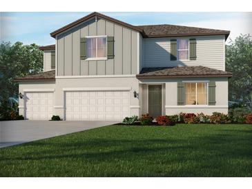 Charming two-story home featuring a two car garage and welcoming front lawn at 1818 Draughton Dr, Zephyrhills, FL 33541