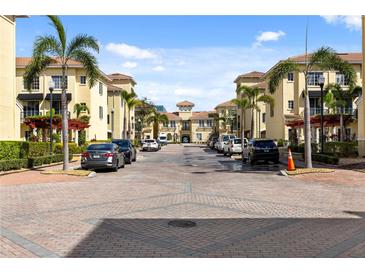 Inviting street view featuring a brick road, charming architecture, and lush landscaping with palm trees at 116 S Obrien St, Tampa, FL 33609