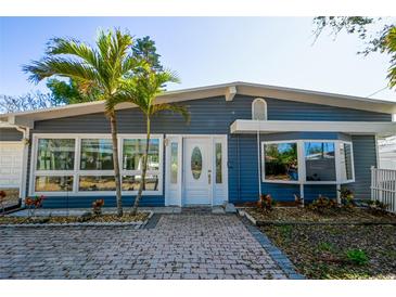Charming single-story home featuring a brick walkway, lovely landscaping and a delightful facade at 10952 61St Ave, Seminole, FL 33772