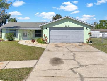 Charming single-story home with a well-manicured lawn, a two-car garage and lovely curb appeal at 523 Red Mangrove Ln, Apollo Beach, FL 33572