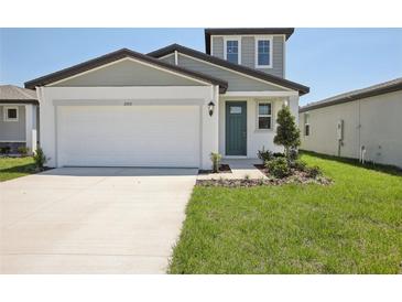 Charming two-story home with a well-manicured lawn and attached two-car garage at 3553 Moscato Dr, Brooksville, FL 34602