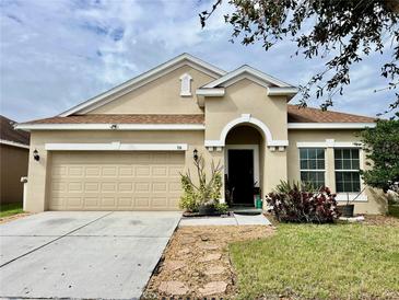 Charming single-story home featuring a two-car garage, neutral paint, and neatly manicured landscaping at 724 Parker Den Dr, Ruskin, FL 33570