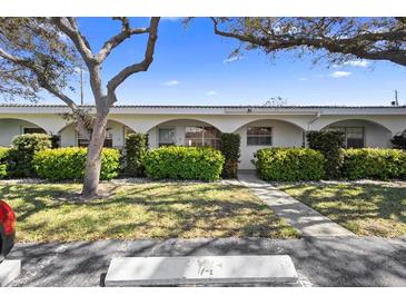 Charming townhome exterior featuring manicured landscaping and inviting curb appeal at 11200 102Nd Ave # 74, Seminole, FL 33778