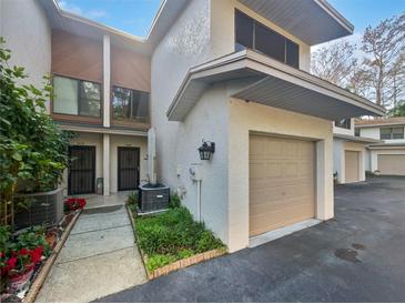 Charming townhouse featuring attached garage, neutral colors, and well-maintained landscaping at 2108 Tarpon Landings Dr, Tarpon Springs, FL 34688