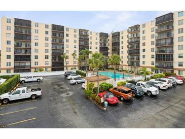 A large condominium building with a swimming pool and parking lot provides comfortable living with convenient amenities at 2901 26Th W St # 317, Bradenton, FL 34205