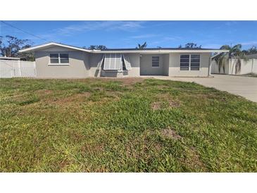 Charming single-story home featuring a well-maintained lawn and classic architectural details at 1540 David Pl, Englewood, FL 34223