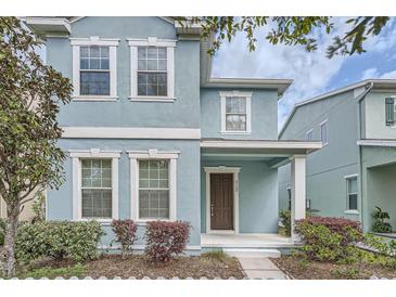 Charming blue two-story home with white trim and a welcoming front porch at 6160 Castleton Hollow Rd, Riverview, FL 33578