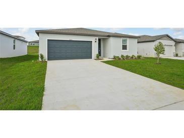 Single Gathering home with a well kept lawn, driveway and attached two-car garage at 31622 Malbec Ln, Brooksville, FL 34602