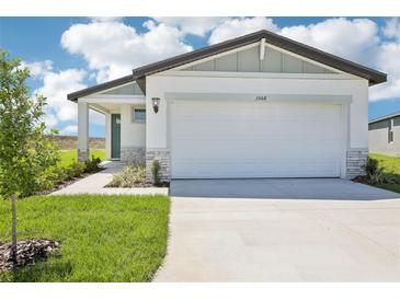Charming single-Gathering home featuring a manicured lawn and attached two-car garage at 3568 Moscato Dr, Brooksville, FL 34602