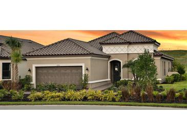 Charming single Gathering home featuring desert landscaping, a tile roof, and an attached two-car garage at 6243 Plateau Ct, Bradenton, FL 34203