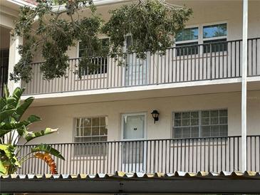 A view of the outside of the building with balconies and railings, showcasing the structure's architectural details at 840 Virginia St # 202, Dunedin, FL 34698