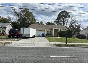 Charming single-story home featuring a two-car garage and a well-maintained front yard at 9476 Spring Hill Dr, Spring Hill, FL 34608