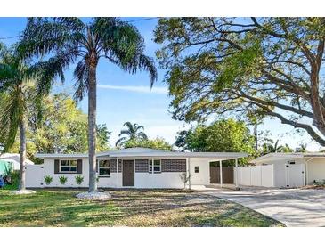 Charming single-story home featuring a spacious front yard, carport, and updated exterior paint at 3116 Karen Ave, Largo, FL 33774