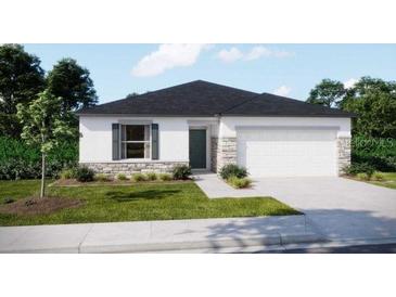Charming one-story home with stone accents, a two-car garage, and a well-manicured lawn at 2258 Sulstone Dr, Punta Gorda, FL 33983