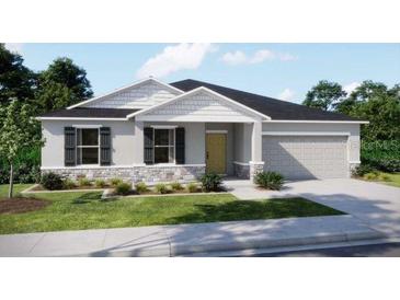 Charming single-story home with a stone facade, well-manicured lawn, and a two-car garage at 2349 Broadpoint Dr, Punta Gorda, FL 33983