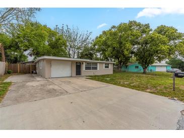 Charming single-story home featuring a spacious front yard, long driveway and attached single car garage at 4129 Highland Loop, New Port Richey, FL 34652