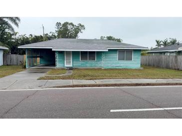 Charming single-story home with a carport and quaint front yard at 2155 Webber St, Sarasota, FL 34239