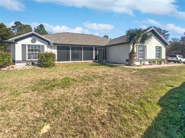 Charming single-story home with neutral paint, shutters, well maintained landscaping, and screened in porch at 6191 Silverdale Ave, Spring Hill, FL 34608