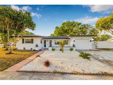 Charming single-Gathering home with well-maintained landscaping and a lovely walkway leading to the entrance at 5980 32Nd N Ave, St Petersburg, FL 33710
