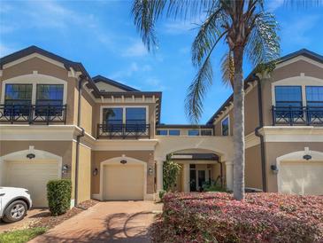 Inviting two-story townhome with charming curb appeal and paver driveway at 1998 Milkweed Trce, Lutz, FL 33558