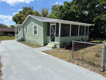Charming home with a screened porch and freshly painted exterior and driveway at 3615 E Grove St, Tampa, FL 33610
