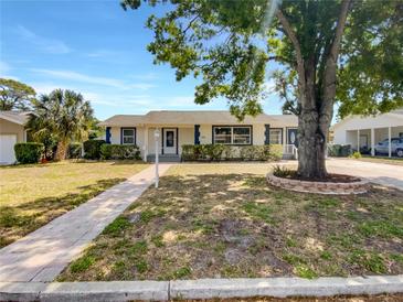 Charming single-story home features a well-maintained lawn, classic design, and inviting walkway at 1115 31St W St, Bradenton, FL 34205