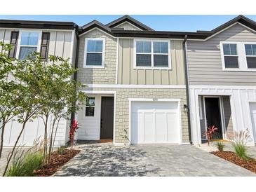 Charming two-story townhome featuring a one-car garage and neutral-toned exterior at 7270 Deer Valley Cir, Tampa, FL 33635