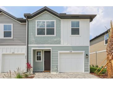 Charming townhome featuring a garage, and a neatly paved driveway leading to the entrance at 7274 Deer Valley Cir, Tampa, FL 33635