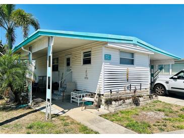 Charming single-story home featuring a covered porch, carport and manicured landscaping at 9790 66Th N St # 238, Pinellas Park, FL 33782