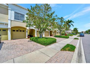 Inviting townhomes featuring attached garages, well-manicured landscaping, and brick paved driveways at 4062 Overture Cir # 4062, Bradenton, FL 34209