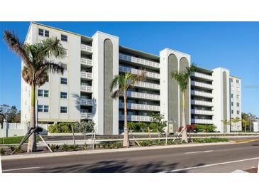 Six-story condo building exterior featuring balconies and palm trees at 7321 Central Ave # 504, St Petersburg, FL 33710