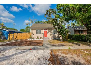 Charming single-story home with a well-maintained lawn, complemented by a bright red front door at 2333 33Rd S St, St Petersburg, FL 33712