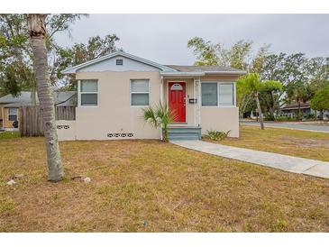 Charming single-story home with a bright red front door and well-maintained lawn at 2001 16Th S St, St Petersburg, FL 33705