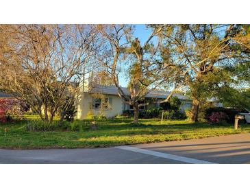Charming single-story home featuring a well-maintained lawn and mature trees at 6639 Renaldo S Way, St Petersburg, FL 33707