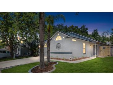 Charming home with a manicured lawn, decorative front, and a well-lit exterior, perfect for evening enjoyment at 754 Cape Cod Cir, Valrico, FL 33594