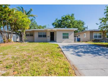 Charming single-story home with a well-maintained lawn and a classic neutral color palette at 4621 25Th S Ave, St Petersburg, FL 33711