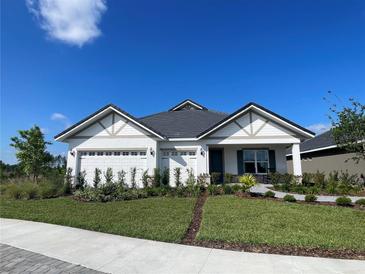 Charming single-story home featuring a three-car garage, manicured lawn, and elegant landscaping at 2726 Wise River Lane, Zephyrhills, FL 33539