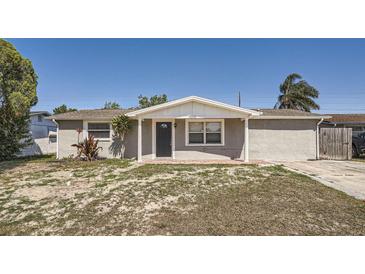 Charming single-story home featuring a covered entrance and brick walkway to the front door at 3206 Peterborough St, Holiday, FL 34690