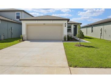 Charming home featuring a spacious driveway, two car garage and well-manicured front lawn at 3536 Moscato Dr, Brooksville, FL 34602