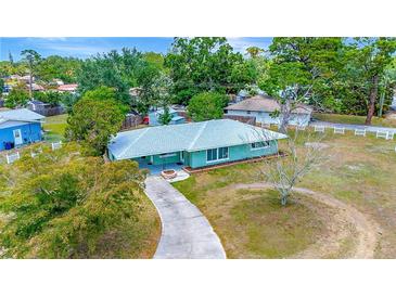 Charming single-story home boasts mature trees, long driveway, and a cozy front porch, exuding curb appeal at 5208 30Th W St, Bradenton, FL 34207