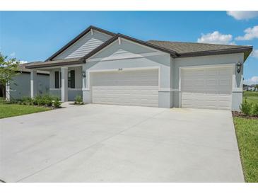 Charming single-Gathering home featuring a three-car garage and well-manicured lawn at 13839 Richland Gulf Cir, Parrish, FL 34219