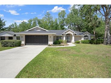 Charming single-story home boasts a well-manicured lawn and inviting curb appeal at 621 Erin Way, Brooksville, FL 34601