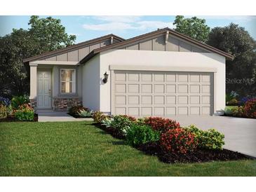 Charming single-story home with a two-car garage, stone accents, neutral colors, and well-maintained landscaping at 14110 Crutchfield Ct, Parrish, FL 34219