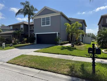 Charming two-story home featuring a well-maintained lawn, beautiful landscaping, and a two-car garage at 3721 Heron Island Dr, New Port Richey, FL 34655