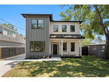 Charming two-story home with light gray and white exterior paint and black trim at 4115 N Central Ave, Tampa, FL 33603